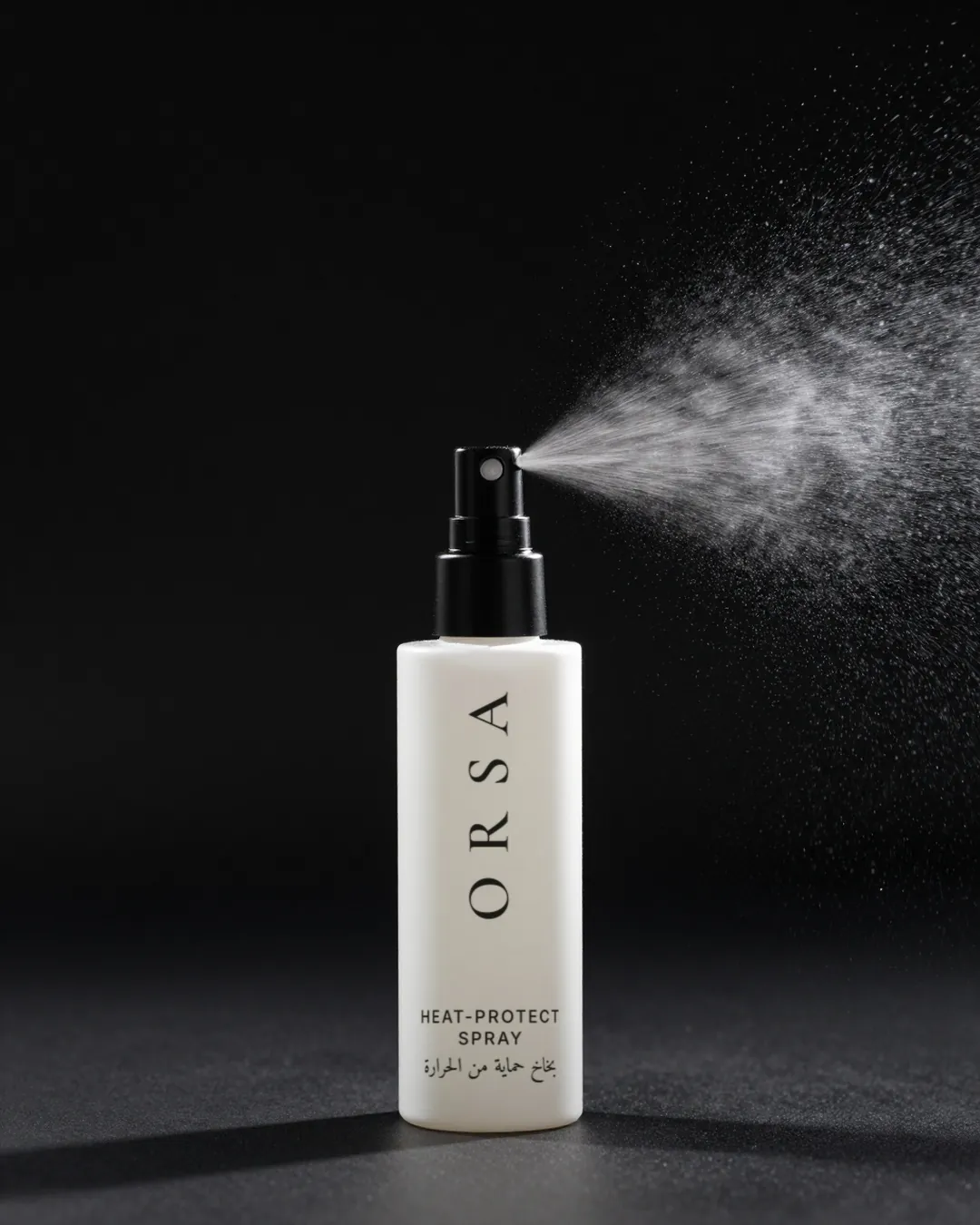 ORSA heat-protect spray misting against a dark background